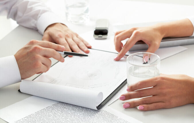 Two people consulting a sketch
