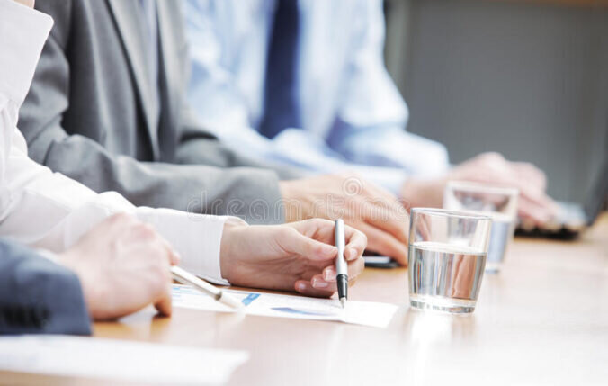 Three people consulting a document