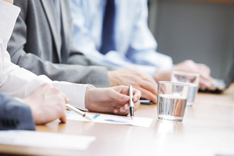 Three people consulting a document