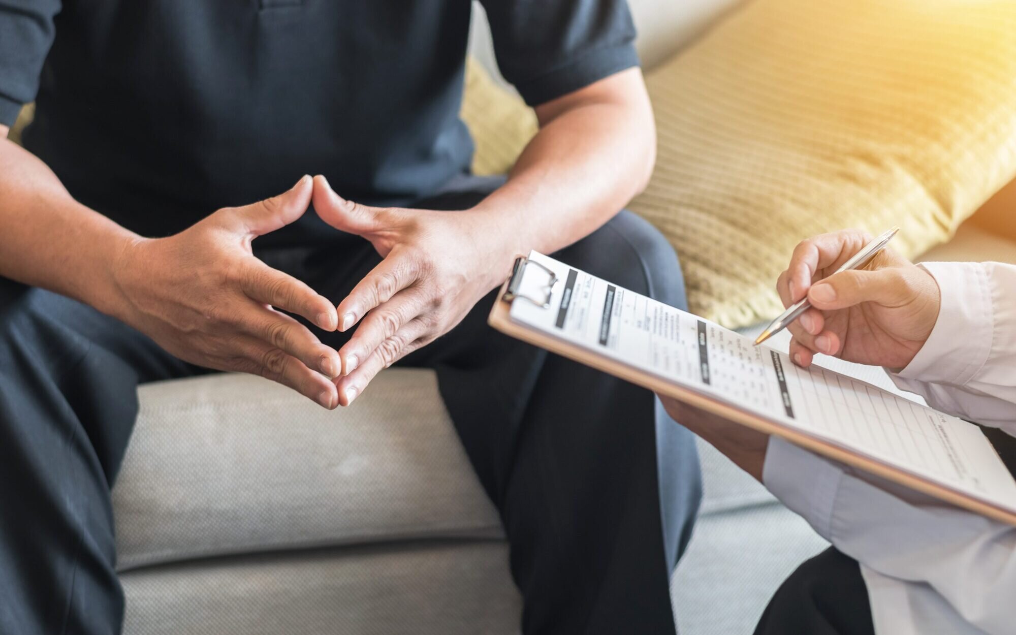 A person with a clipboard asking questions to another person