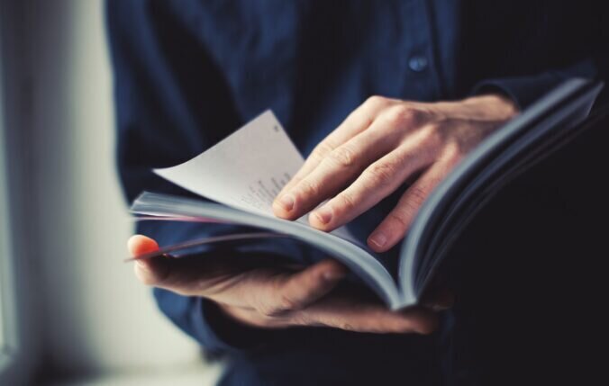 A person flicking through the pages of a book