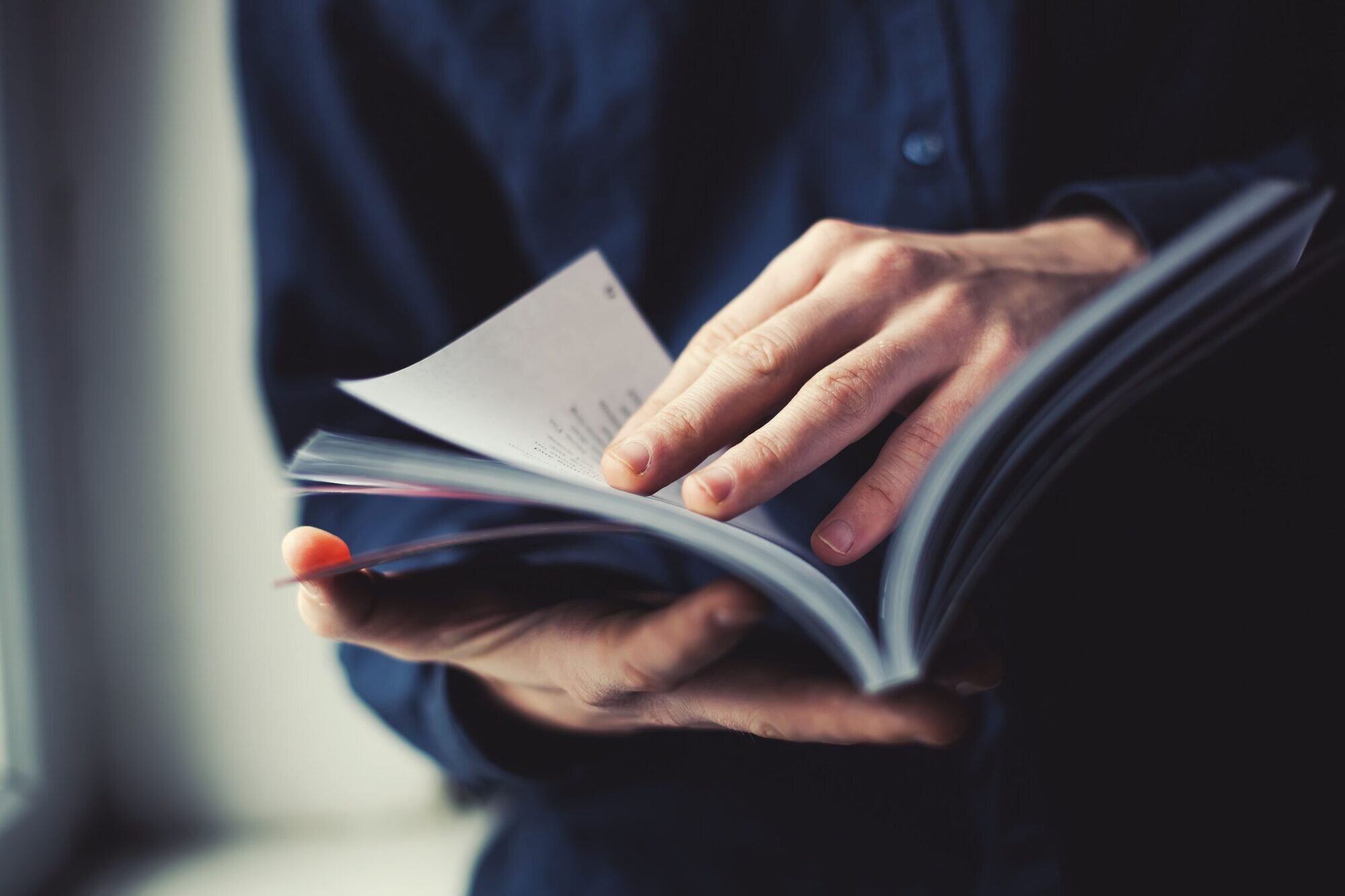 A person flicking through the pages of a book