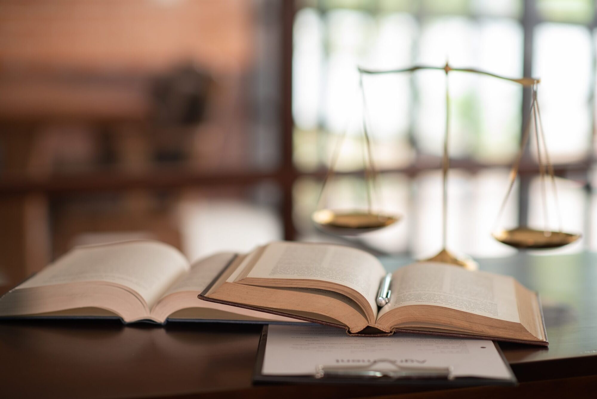 Law Books And Scales Of Justice On Desk