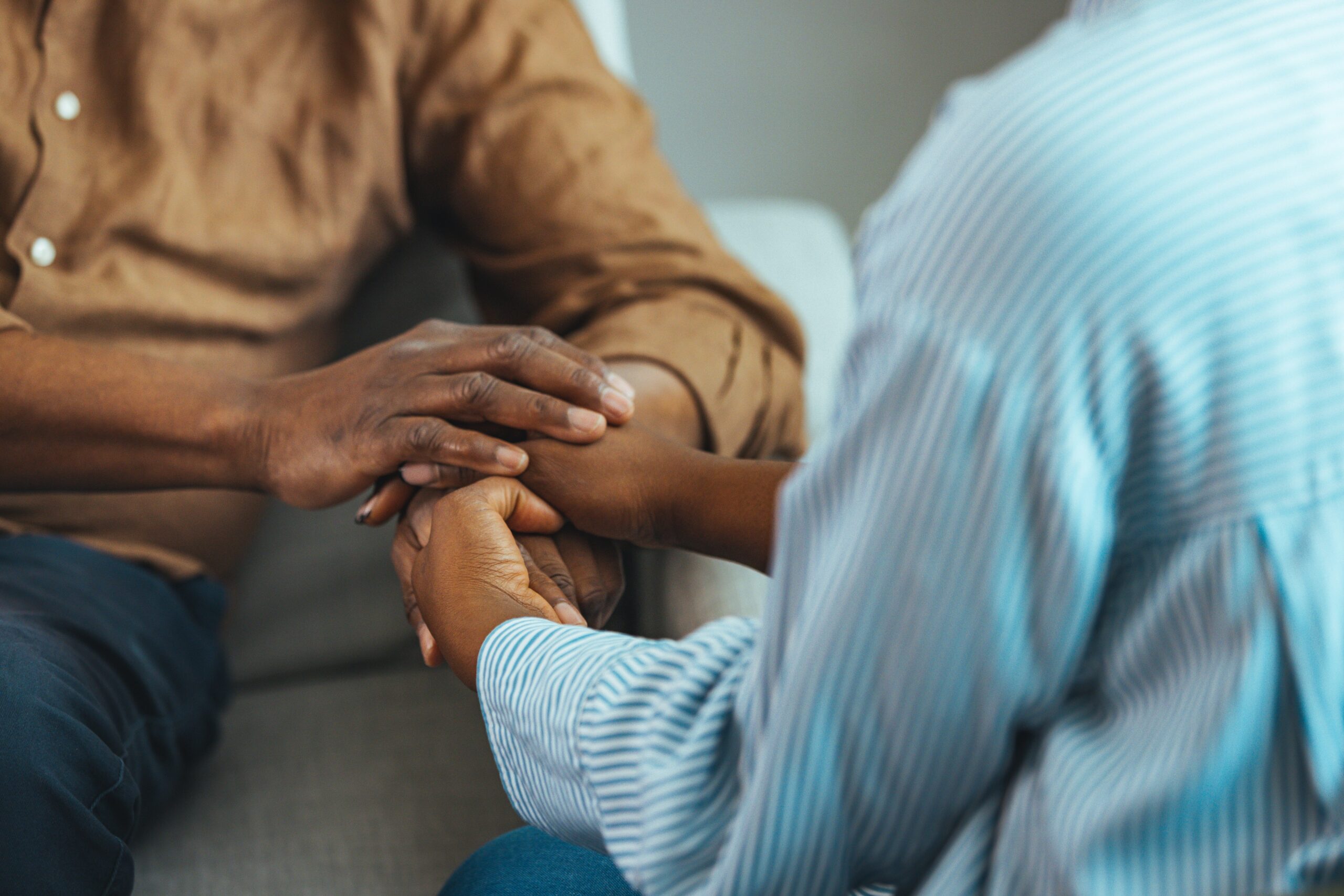 A person holding another person's hands in support