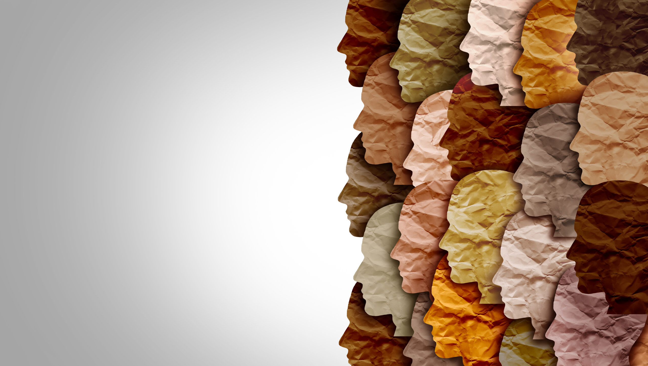 Faces made out of different coloured paper to signify different skin tones