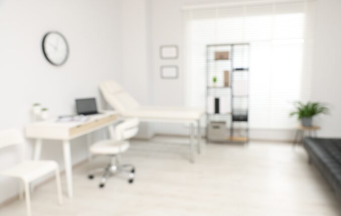 Blurred View Of Modern Medical Office With Doctor's Workplace